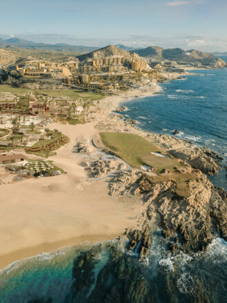 a beach with buildings and a golf course