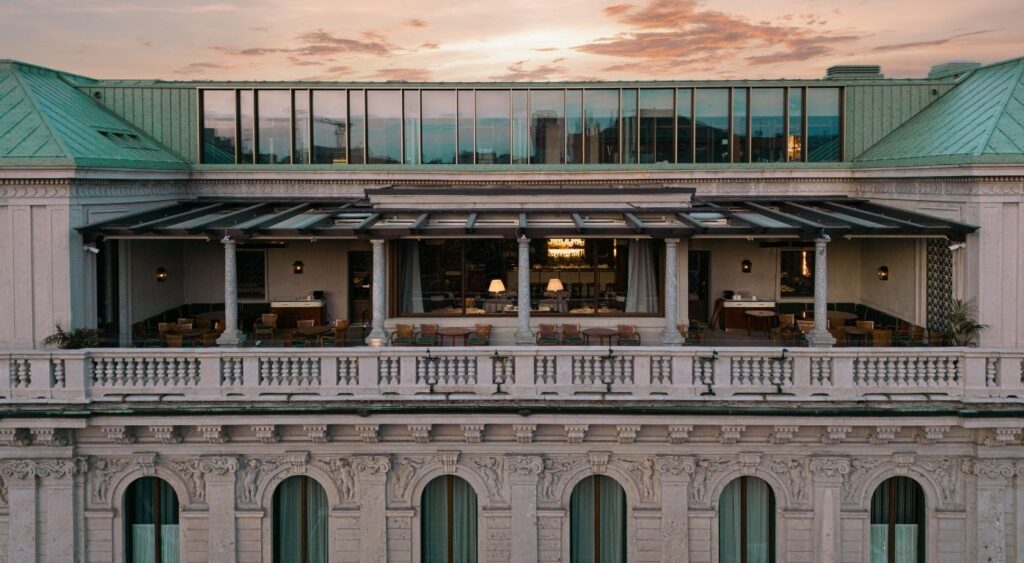 Luxury hotels in Milan - Casa Cipriani Milano - Corso Venezia - The hotel's rooftop restaurant with the sunset in the background