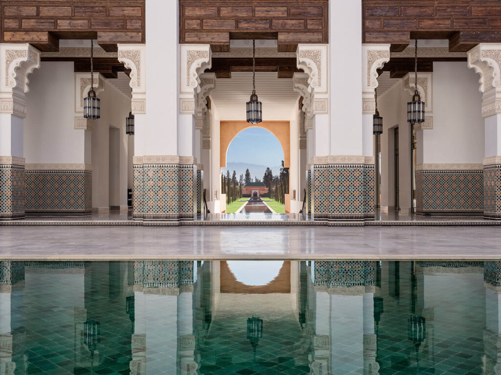 Family Trip to Morocco Travel Diary by Anna Cort | An intricate pool and view of the hotel grounds and Atlas Mountains at The Oberoi, Marrakech, Morocco