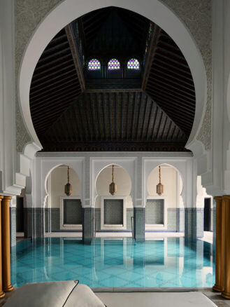 Family Trip to Morocco Travel Diary by Anna Cort | a large indoor pool with blue water and tiles at The Oberoi, Marrakech, Moroco