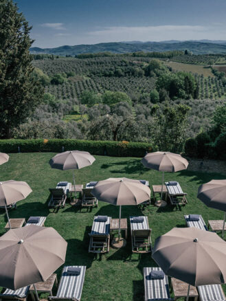 Tuscany Hotels Travel Diary by Shelbi Okumura | COMO Castello Del Nero loungers and umbrellas with Tuscan views