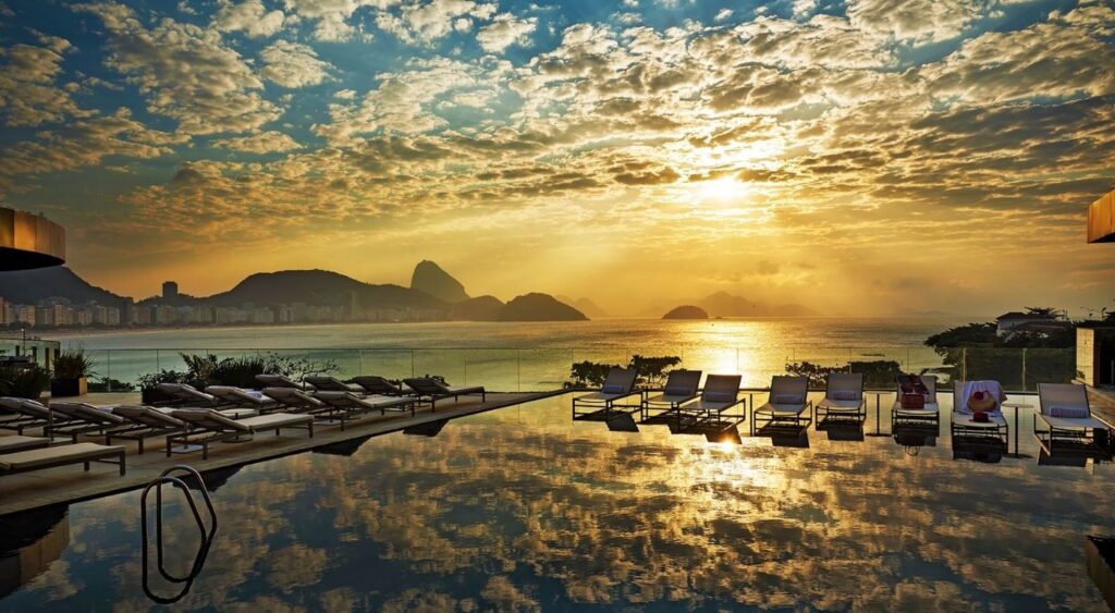 Exclusive experiences - Fairmont Rio de Janeiro Copacabana - Rio de Janeiro, Brazil - Infinity pool overlooking Copacabana Beach at sunset