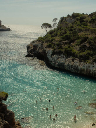 Portugal and Spain Travel Diary Itinerary by Christine Flynn | a group of people swimming in a body of water in Mallorca, Spain