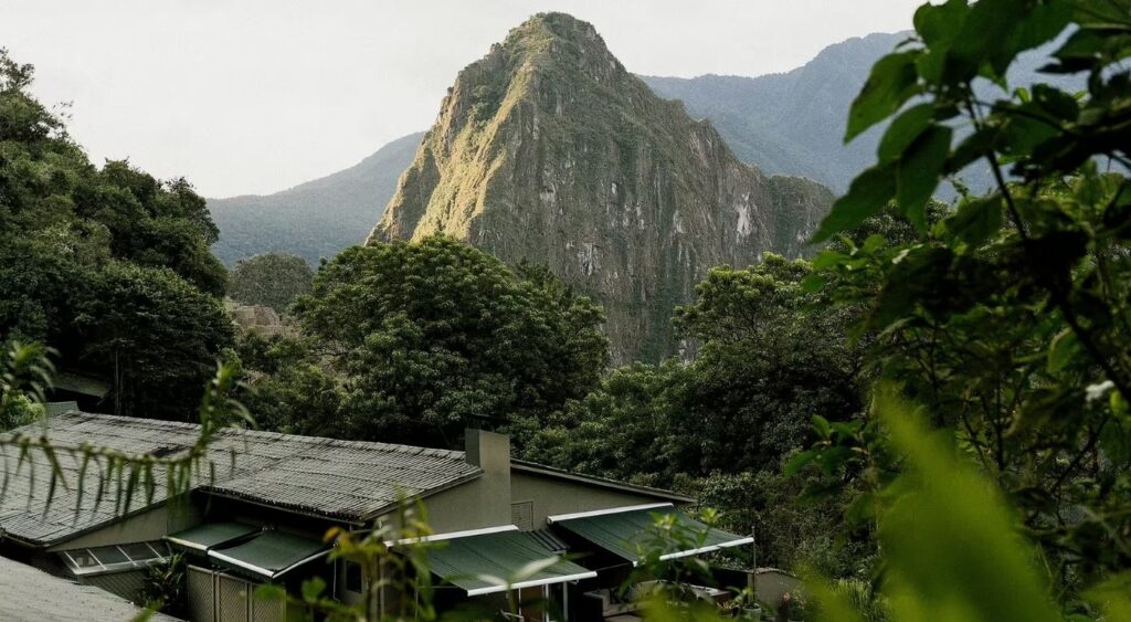 Exclusive experiences - Sanctuary Lodge, A Belmond Hotel, Machu Picchu - Machu Picchu, Peru - Aerial view of the hotel with a mountain in the back