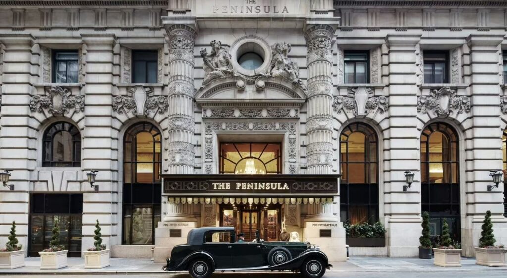 Exclusive experiences - The Peninsula New York - New York City, New York - Street view of the hotel with a black car in front