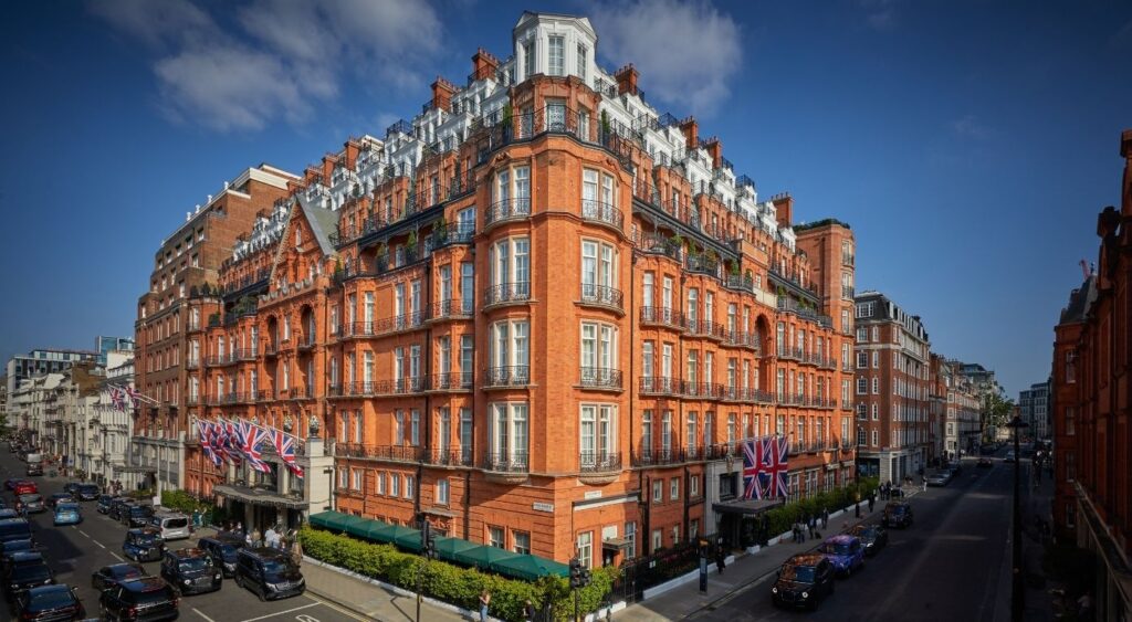 Luxury hotels in London - Mayfair - Claridge’s - Hotel with red bricks and Union Jacks