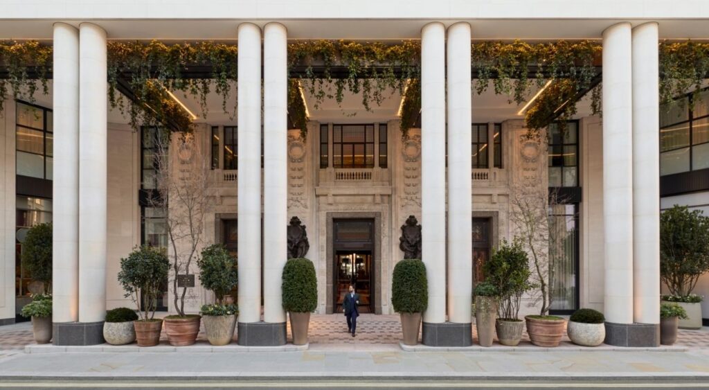 Luxury hotels in London - Notting Hill - Six Senses London - Exterior of hotel with a person walking between the columns