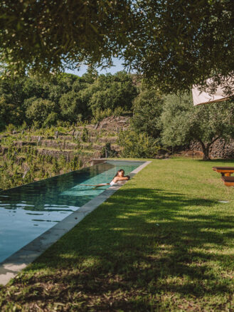 Where to stay in Sicily travel diary - a woman in an outdoor pool at Monaci delle Terre Nere Etna Wine Resort.