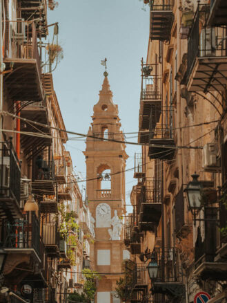 Where to stay in Sicily travel diary - view of apartment balconies and a church in the background in Palermo